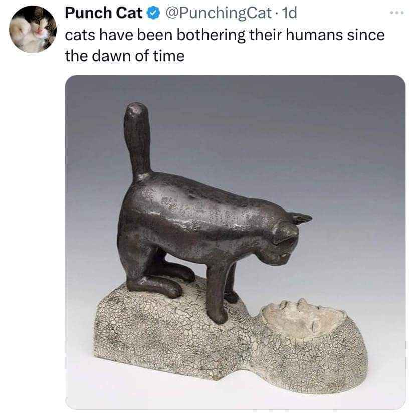 This statue perfectly captures cats bothering their humans throughout history.