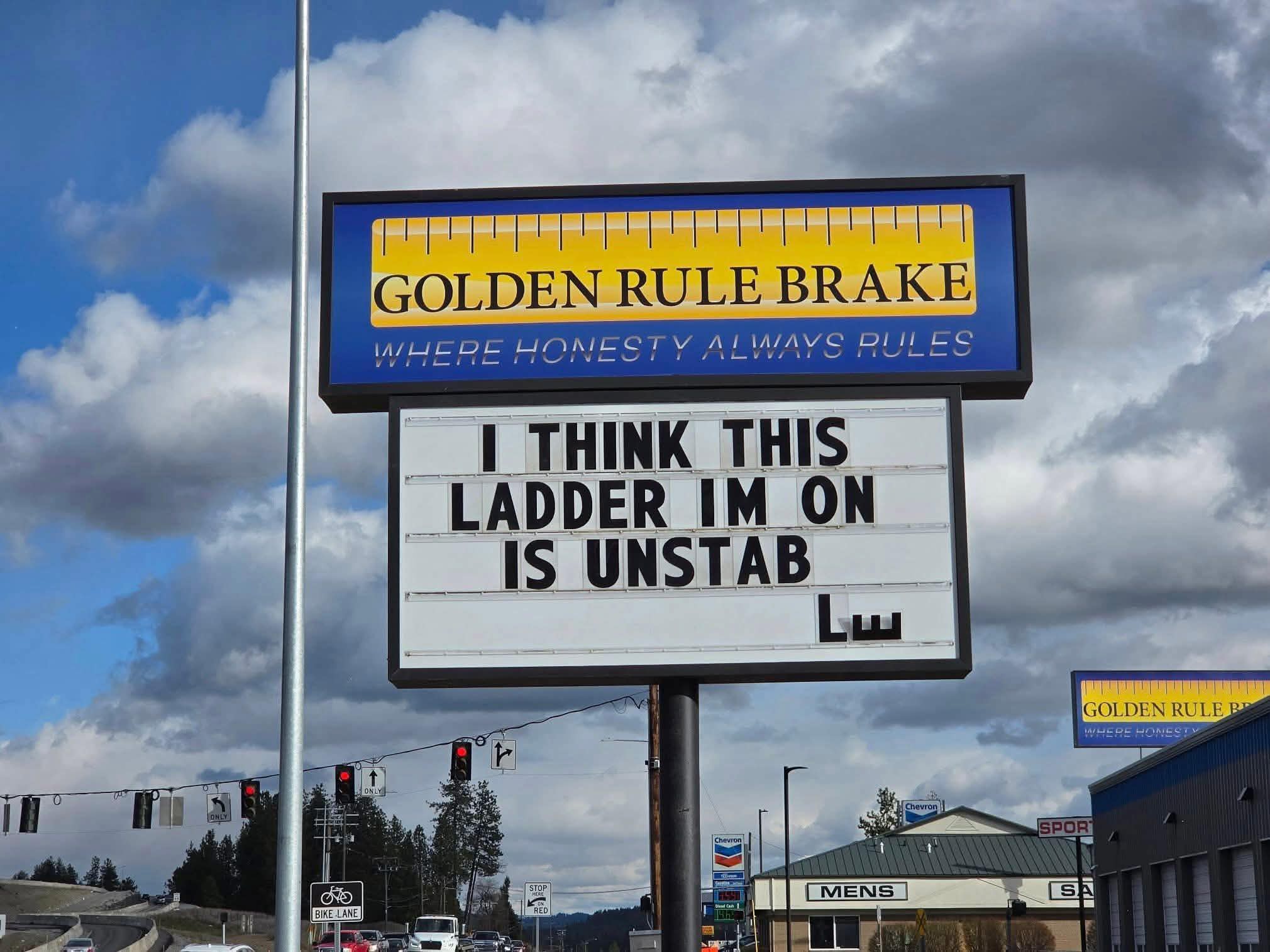 When the sign says "honesty always rules" but then they admit they're on an unstable ladder