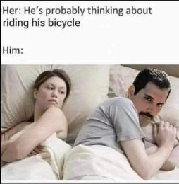 She thinks he's thinking about riding his bicycle but he's clearly thinking about Freddie Mercury.