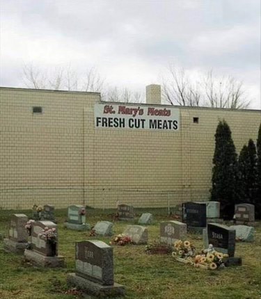 Well, this sign is definitely giving off some weird vibes next to a cemetery.