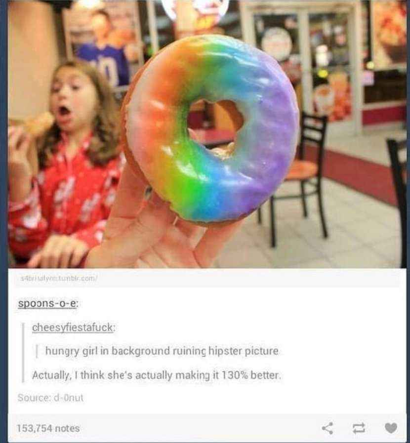 This girl is living her best life while someone else is trying to take a 'cool' pic of a rainbow donut