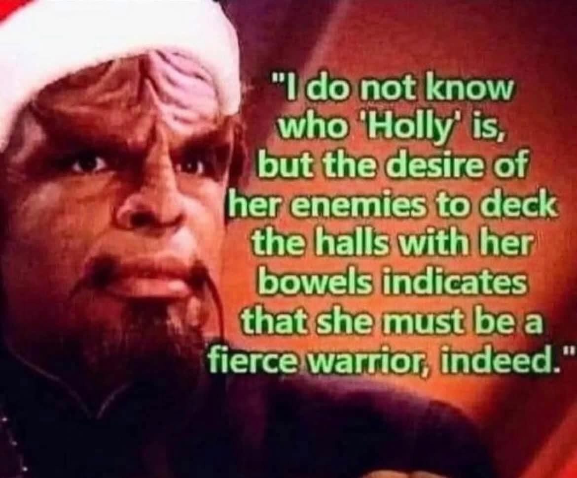 This Klingon is trying to figure out the true meaning of Christmas carols, specifically 'Deck the Halls'.