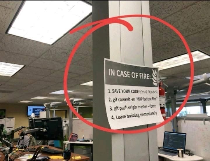 This sign is a whole mood for anyone who's ever coded. 'WIP before fire' is just... chef's kiss.