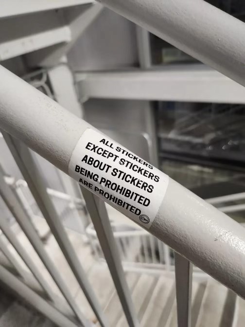 Lol, someone put a sticker on the railing that says all stickers are prohibited except stickers about stickers being prohibited. Peak irony.