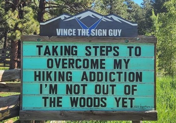 This sign is trying to overcome a hiking addiction but lol they're still in the woods
