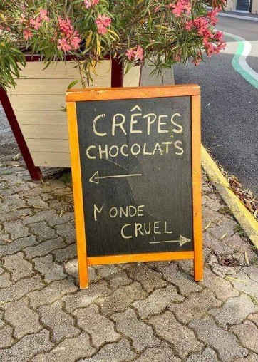 Guess which way leads to the cruel world and which way is for crepes and chocolate.